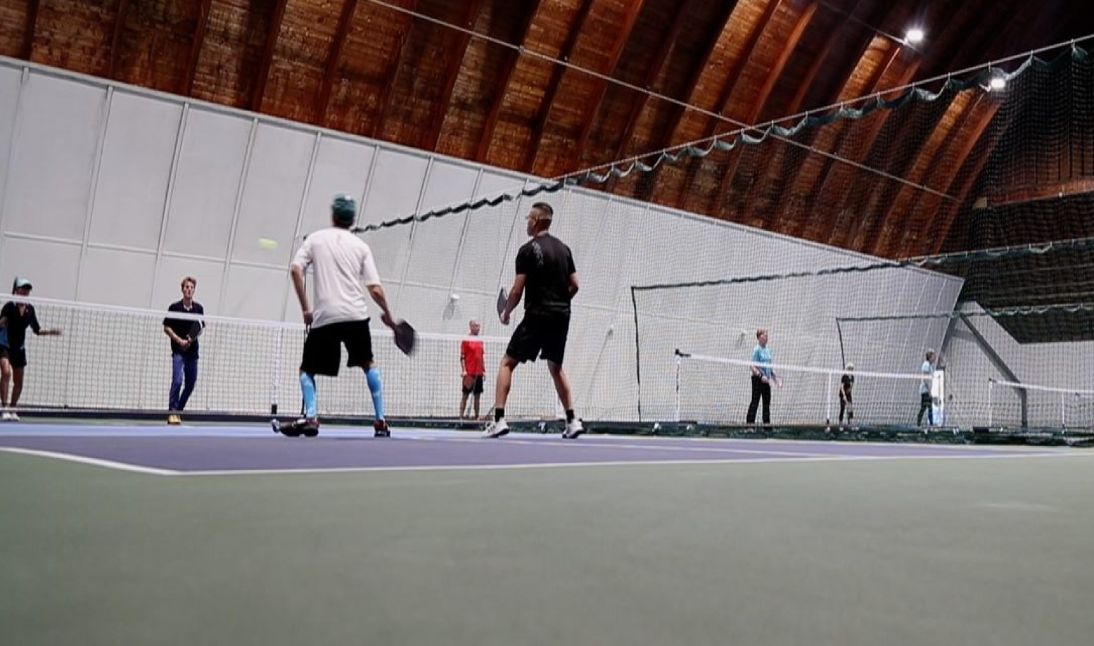 People playing pickleball on a pickleball court